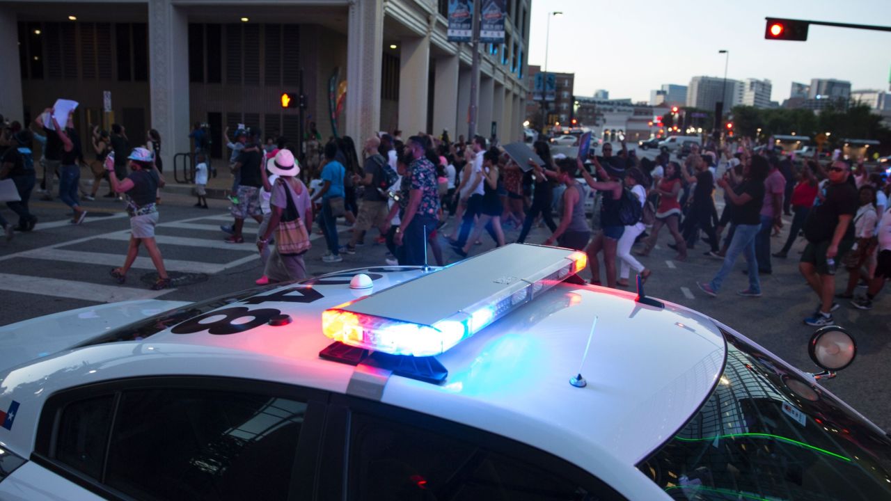 People rally in Dallas, Texas, on Thursday, July 7, 2016 to protest the deaths of Alton Sterling and Philando Castile.
Black motorist Philando Castile, 32, a school cafeteria worker, was shot at close range by a Minnesota cop and seen bleeding to death in a graphic video shot by his girlfriend that went viral Thursday, the second fatal police shooting to rock America in as many days. / AFP / Laura Buckman        (Photo credit should read LAURA BUCKMAN/AFP/Getty Images)