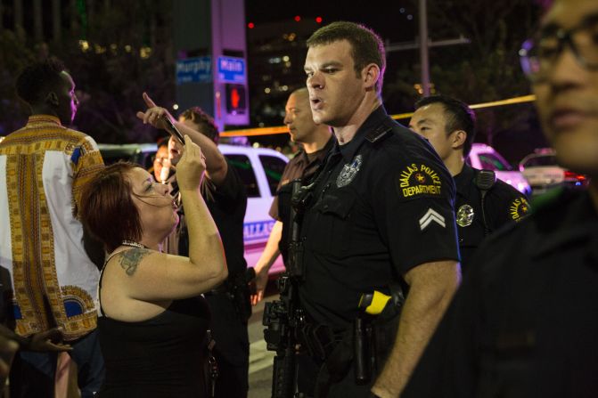 Police attempt to calm the crowd after an arrest.