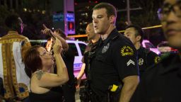 Police attempt to calm the crowd as someone is arrested following the sniper shooting in Dallas on July 7, 2016. 
A fourth police officer was killed and two suspected snipers were in custody after a protest late Thursday against police brutality in Dallas, authorities said. One suspect had turned himself in and another who was in a shootout with SWAT officers was also in custody, the Dallas Police Department tweeted.
 / AFP / Laura Buckman        (Photo credit should read LAURA BUCKMAN/AFP/Getty Images)