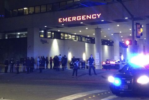 Police and others gather at the emergency entrance to the Baylor University Medical Center.