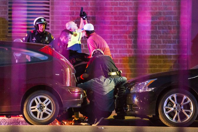 Police officers shield bystanders after shots were fired at the protest.