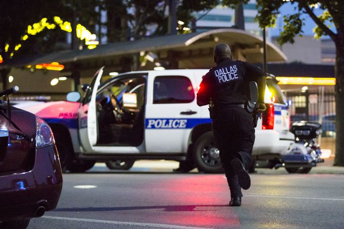 Dallas police respond to the scene of the shootings.