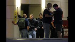 Law enforcement officials wait outside the emergency room entrance at Baylor University Medical Center.