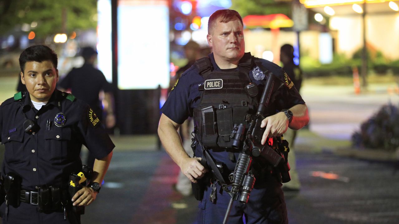 Dallas police stand near the scene where four Dallas police officers were shot and killed on July 7.