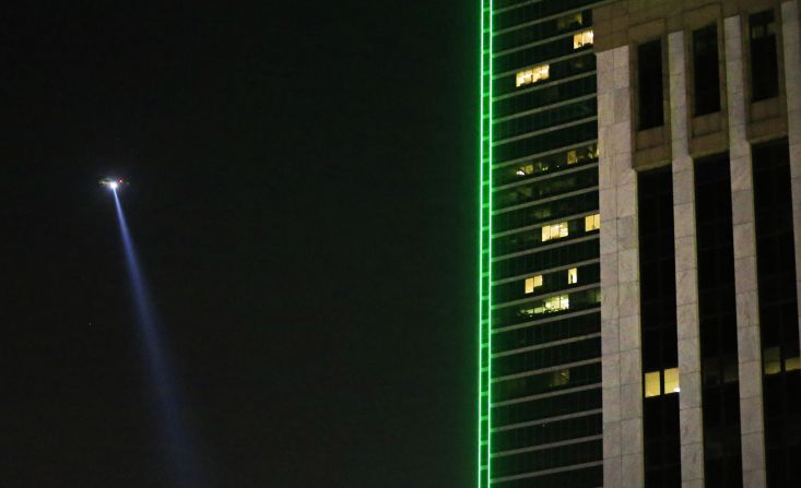 A police helicopter flies over the scene in downtown Dallas. One suspect was killed by police after a standoff that lasted for hours.