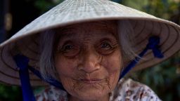 In this picture taken on June 27, 2015 an elderly woman smiles while working in a market in Hoi An, Vietnam's central Quang Nam Province. The old town area of Hoi An, a well-preserved example of a traditional Asian trading port, is recognized as a UNESCO World Heritage Site and is a popular travel destination for local and international tourists. AFP PHOTO / DALE DE LA REY        (Photo credit should read DALE de la REY/AFP/Getty Images)