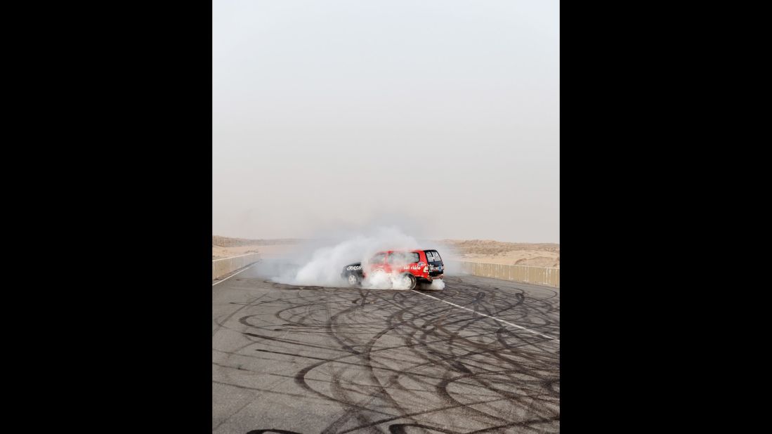 An SUV slides on a stretch of asphalt in Umm al-Quwain, one of the emirates in the United Arab Emirates. Photographer Peter Garritano documented the youth culture of "hajwalah," or drifting vehicles for sport.