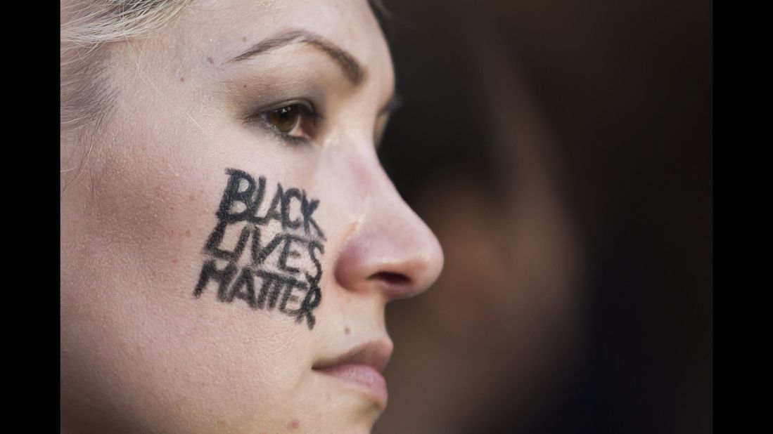 A woman with "Black Lives Matter" on her cheek joins other protesters. As the march began and although the police presence was considerable, Pool said everyone was positive.