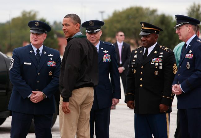 U.S. President Barack Obama is greeted by a military personnel as he arrives at at Offutt Air Force Base in Omaha, Nebraska, on August 13, 2012.