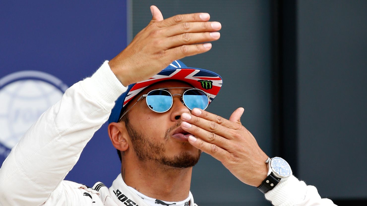 Lewis Hamilton of Great Britain blows kisses to the crowds after qualifying in pole position for Sunday's British Grand Prix at Silverstone.