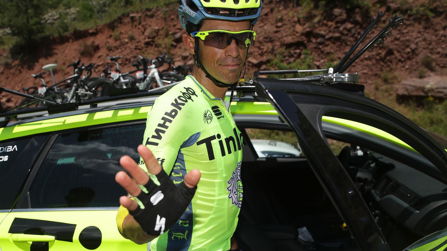 Alberto Contador of Spain climbs into the Tinkoff team car to abandon the Tour de France on the ninth stage. 