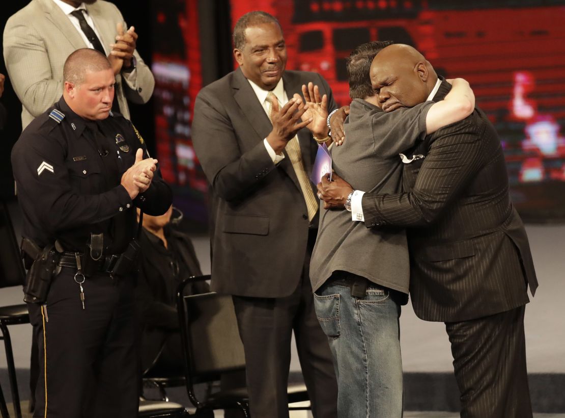 Bishop T.D. Jakes hugs DART Officer Steve Gentry.