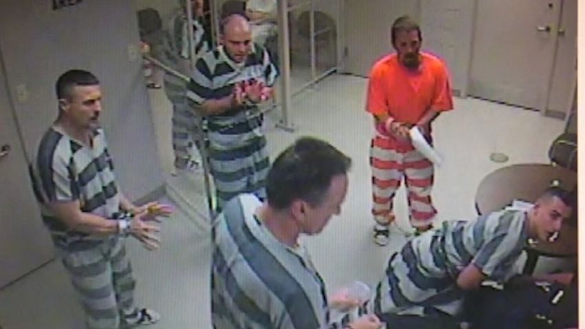 Inmates bust out of a holding cell to assist a corrections officer who experienced a medical emergency.