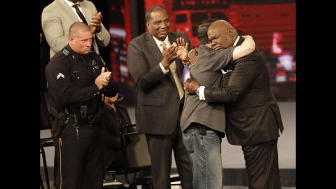 Bishop T.D. Jakes, hugs first responder during a service that included a memorial to the five officers killed in Dallas. 
