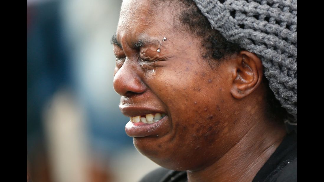 The pain was just too much for Tawandra Carr to bear. Carr, who said she was best friends with Alton Sterling, cries when she and others gathered outside the Triple S convenience store where Sterling was killed by police, trying to make some sense of an incident that launched days of soul-searching in America.