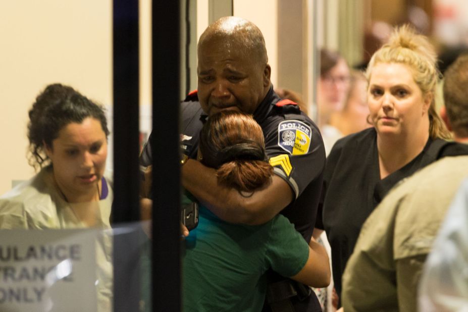 Few other photos captured the sadness and grief of the shooting deaths of five Dallas officers as this photograph of a sobbing DART (Dallas Area Rapid Transit) police officer being comforted at the Baylor University Hospital.