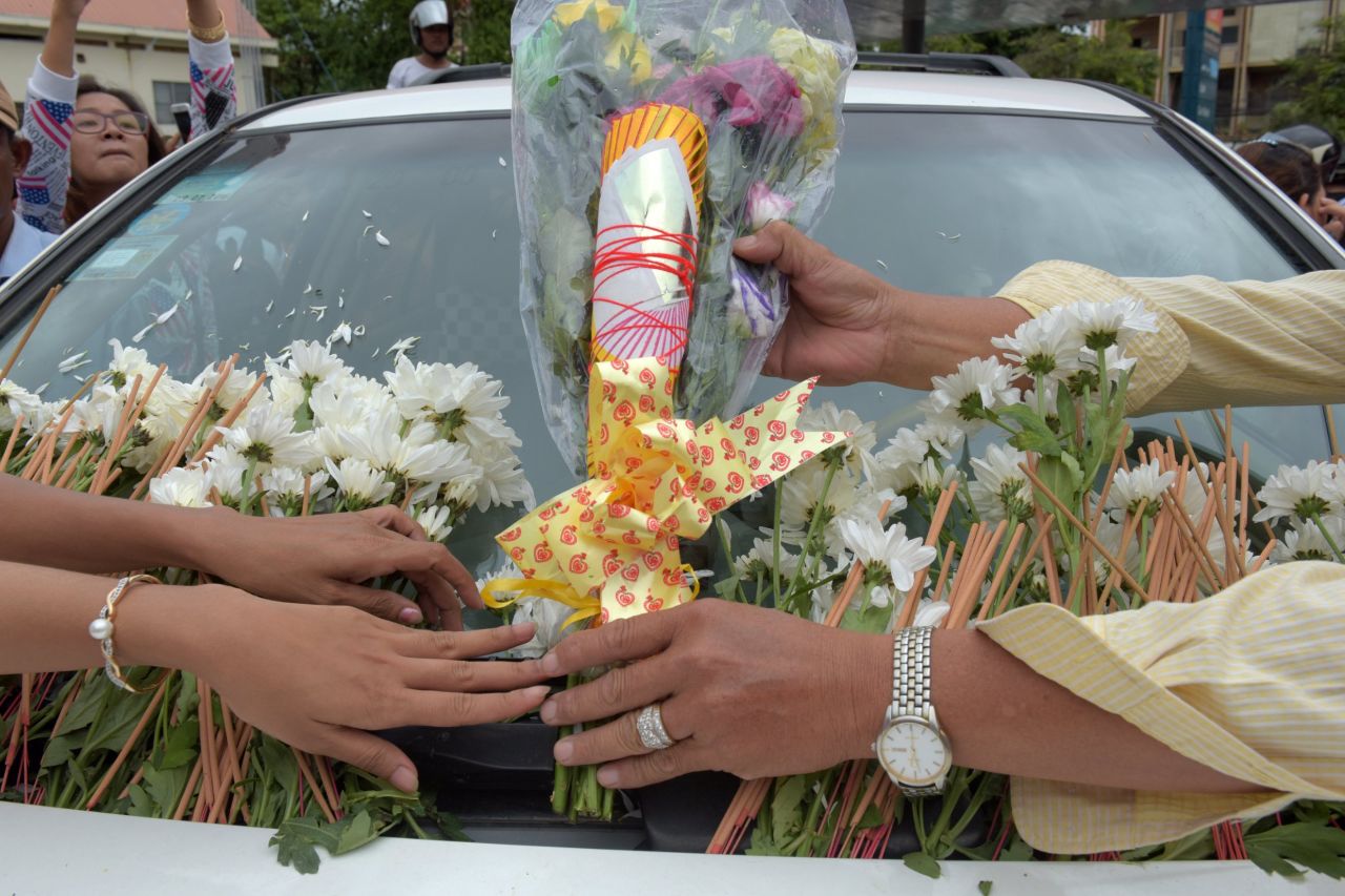 Flowers lay on a car carrying Kem Ley's body. 