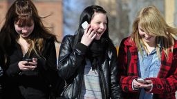 Teenagers use cell phones after school time in Vaasa on March 30, 2010.   AFP PHOTO OLIVIER MORIN. (Photo credit should read OLIVIER MORIN/AFP/Getty Images)