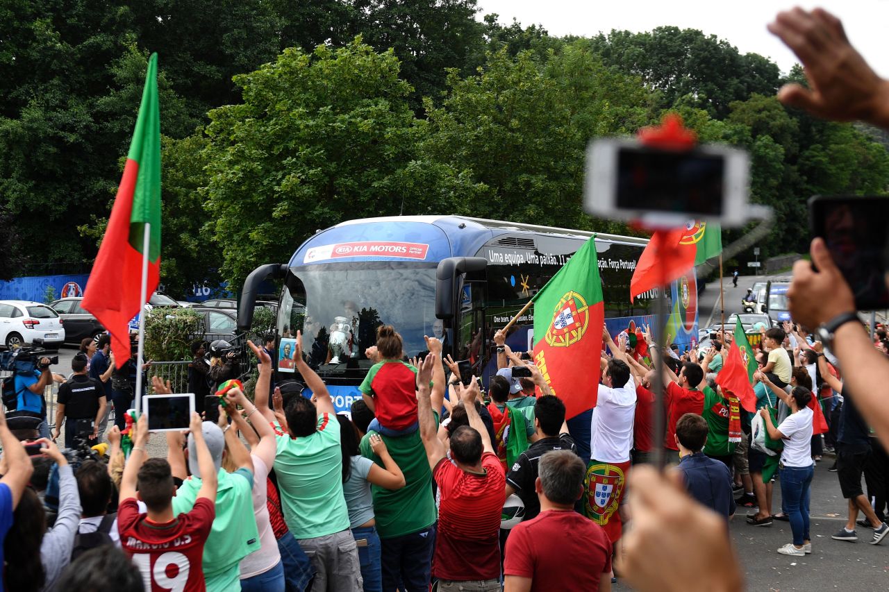After celebrating long into the night after beating France in the Euro 2016 final, exultant Portugal fans gathered around the team bus as the players left their base camp in Marcoussis to return home. 