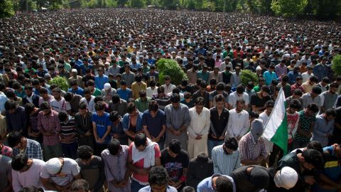 Villagers pray during Saturday's funeral for militant commander Burhan Wani. 