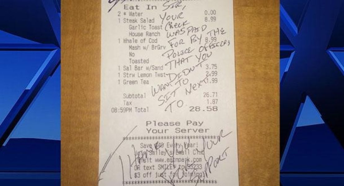 The message left on the bill: "Sir, your check was paid for by the police officers that you didn't want to sit next to. Thank you for your support"