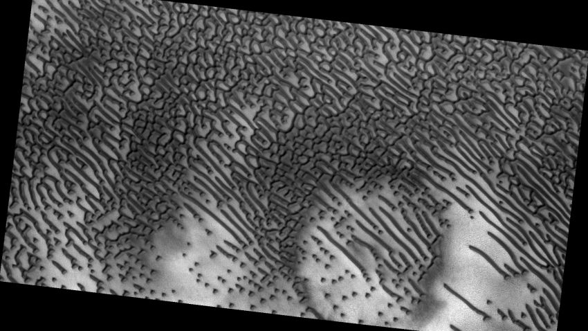 The distinctive dots and dashes are carved in the sands by Martian winds.