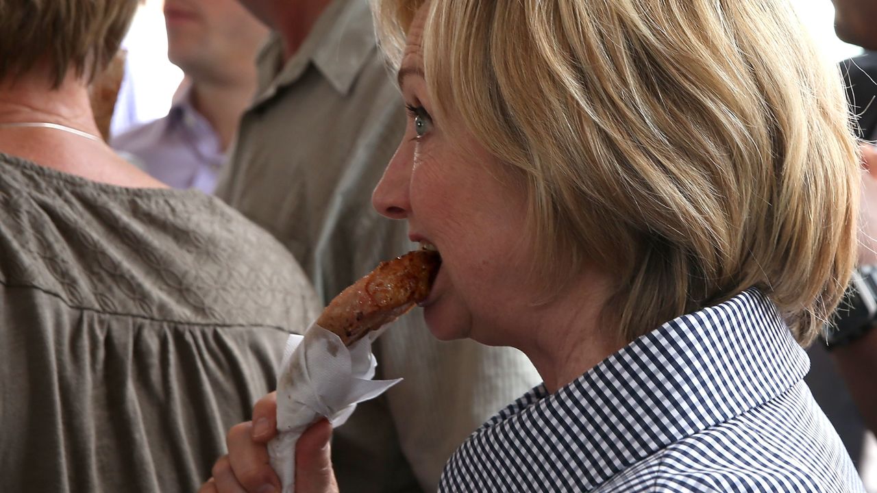 Democratic presidential hopeful and former Secretary of State Hillary Clinton eats a Pork Chop on a Stick as she tours the Iowa State Fair on August 15, 2015 in Des Moines, Iowa.  