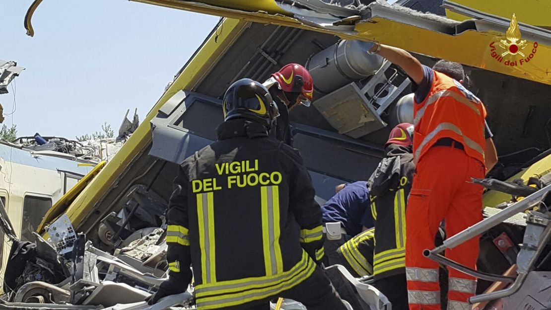 Firefighters inspect the wreckage of two trains after a head-on collision Tuesday in the Puglia region.