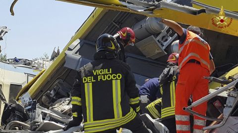 Firefighters inspect the wreckage of two trains after a head-on collision Tuesday in the Puglia region.