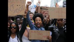 TOPSHOT - Demonstrators from the Black Lives Matter movement march through central London on July 10, 2016, during a demonstration against the killing of black men by police in the US. Police arrested scores of people in demonstrations overnight Saturday to Sunday in several US cities, as racial tensions simmer over the killing of black men by police. / AFP / DANIEL LEAL-OLIVAS        (Photo credit should read DANIEL LEAL-OLIVAS/AFP/Getty Images)