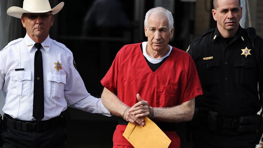 BELLEFONTE, PA - OCTOBER 09: Former Penn State assistant football coach Jerry Sandusky (C) leaves the Centre County Courthouse after being sentenced in his child sex abuse case on October 9, 2012 in Bellefonte, Pennsylvania. The 68-year-old Sandusky was sentenced to at least 30 years and not more that 60 years in prison for his conviction in June on 45 counts of child sexual abuse, including while he was the defensive coordinator for the Penn State college football team. (Photo by Patrick Smith/Getty Images)