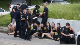 BATON ROUGE, LA -JULY 10: Several arrested protesters get processed on the scene after a march on July 10, 2016 in Baton Rouge, Louisiana. Alton Sterling was shot by a police officer in front of the Triple S Food Mart in Baton Rouge on July 5th, leading the Department of Justice to open a civil rights investigation. (Photo by Mark Wallheiser/Getty Images)