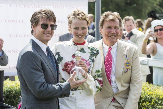 British model Edie Campbell receives the winner's trophy from film star Tom Cruise in 2014.