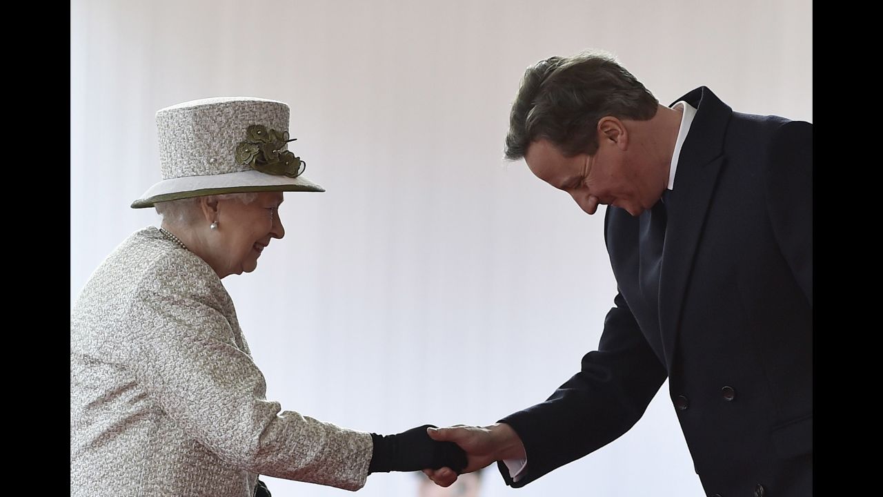 Cameron bows as he greets Queen Elizabeth II during the Mexican President's state visit on March 3, 2015.