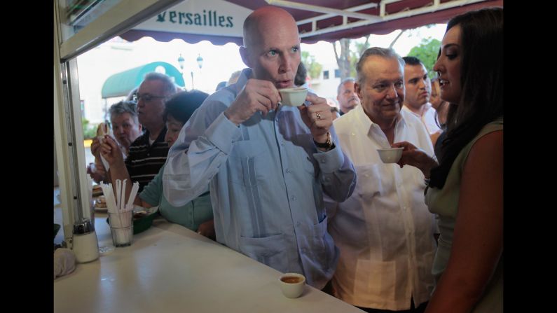 Florida Gov. Rick Scott drinks a Cuban coffee at Versailles Restaurant in Miami during a visit to celebrate the eatery's 40th anniversary in 2011. The restaurant is where U.S. presidents, governors and other politicians come to court the Cuban exile vote.