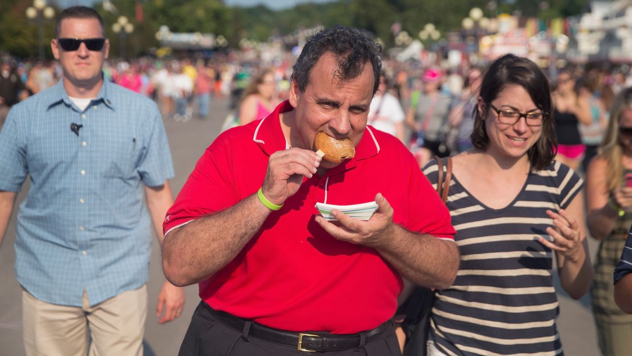 Republican presidential candidate New Jersey Governor Chris Christie samples fried peanut butter and jelly during a visit to the Iowa State Fair on August 22, 2015 in Des Moines, Iowa.