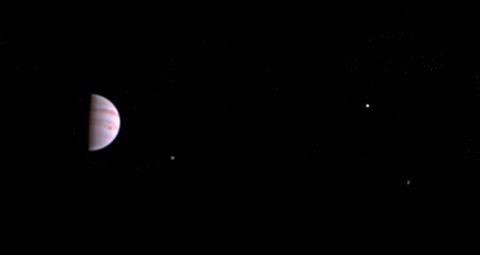 NASA's Juno spacecraft has sent back its first photo of Jupiter, left, since entering into orbit around the planet. The photo is made from some of the first images taken by JunoCam and shows three of the massive planet's four largest moons: from left, Io, Europa and Ganymede.