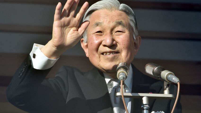 Japanese Emperor Akihito waves to well-wishers gathered for the annual New Year's greetings at the Imperial Palace in Tokyo on January 2, 2016.