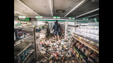 Last month, Malaysian photographer Keow Wee Loong and two colleagues managed to get past authorities and make their way into Fukushima's exclusion zone. The area remains mostly untouched since a 9.0 magnitude earthquake, the worst to ever hit Japan, followed by a tsunami, devastated the country on March 11, 2011. In this photo, Loong is seen at a supermarket full of old merchandise.