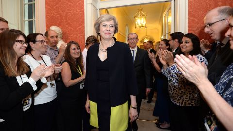 Staff members clap as new Prime Minister Theresa May walks into 10 Downing Street.