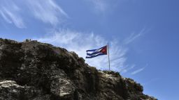 A Cuban flag flutters on top of a rock near the U.S. Embassy in Havana on August 13, 2015.