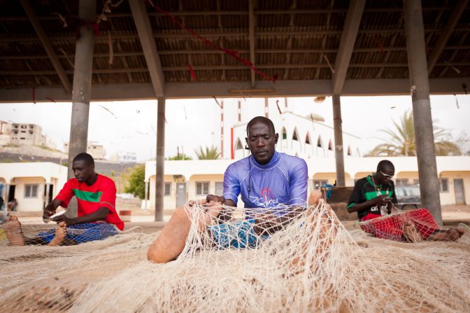 Fishermen check their nets in the fishing port of Ouakam, Dakar.