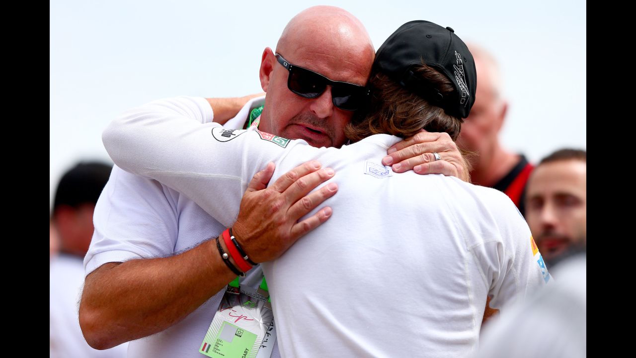Fernando Alonso of Spain comforts Bianchi's father Philippe after the family and F1 drivers observed a minute's silence before the Hungarian GP at the Hungaroring on July 26, 2015 in Budapest, Hungary.
