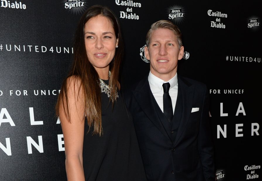 Schweinsteiger and Ivanovic pose for pictures on the red carpet as they arrive to attend the "United for UNICEF Gala Dinner" at Old Trafford in Manchester on November 29, 2015. 
