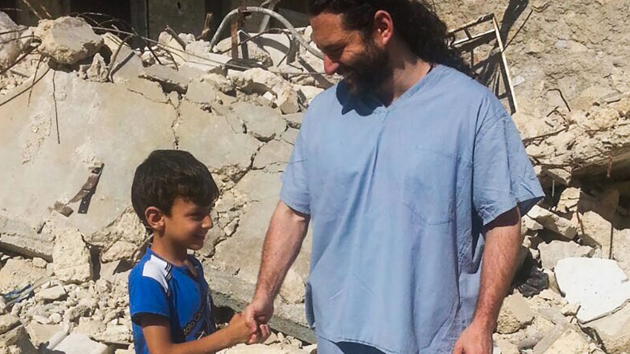 Dr. Samer Attar meeting one of the children who live in eastern Aleppo.