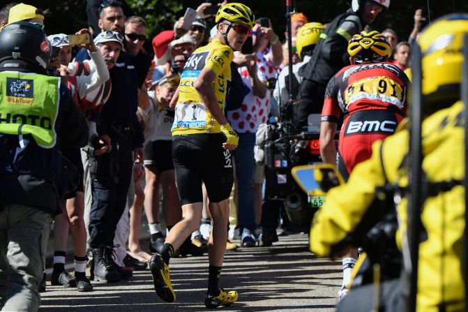 Froome runs to get another bike after falling during the 178 kilometer 12th stage of the 103rd edition of the Tour de France cycling race on July 14, 2016 between Montpellier and Chalet-Reynard.