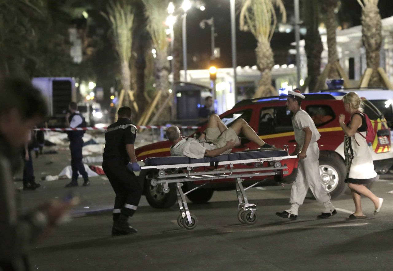 Rescue workers move a victim from the scene. 