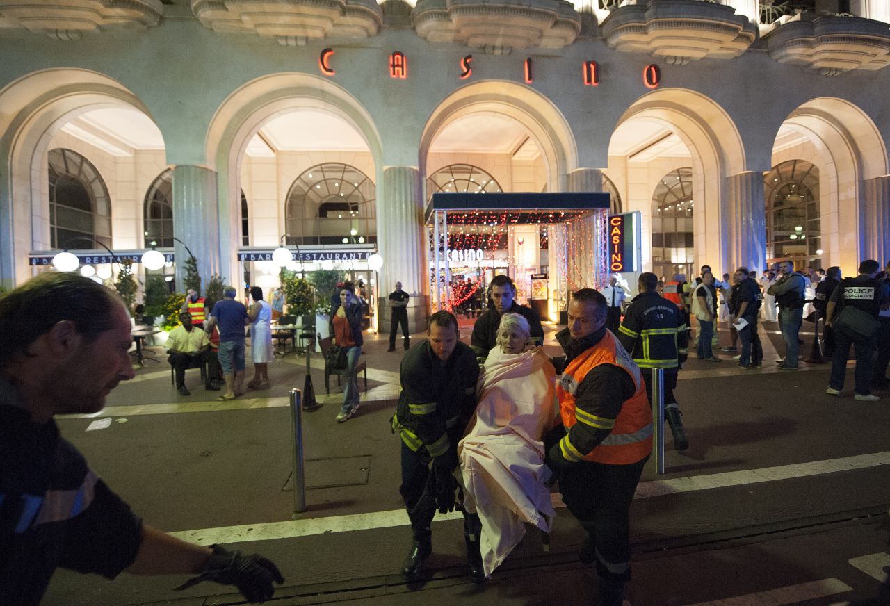 Wounded people are evacuated from the scene where the truck drove into the crowd during the Bastille Day celebrations.