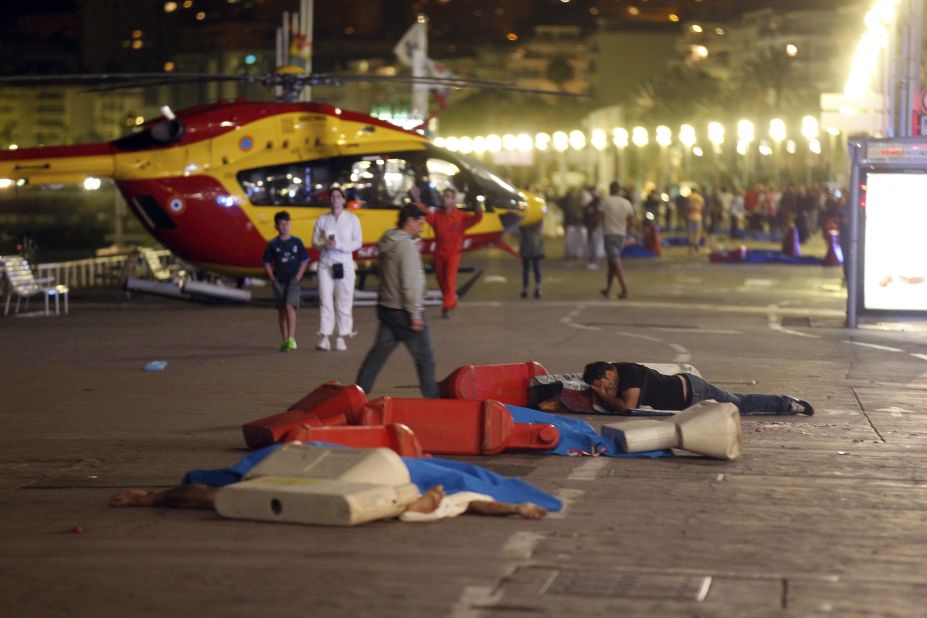A man lies near a covered body at the scene of the attack on the Promenade des Anglais in Nice. 