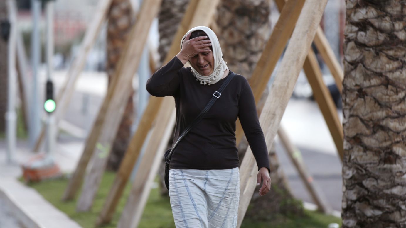 A woman cries, asking for her son, as she walks near the scene of the attack.